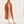 Woman wearing Bogota cream vegan boots styled with long coat and neutral outfit in full body fashion pose