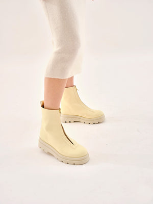 Bogota cream vegan boots for women worn on foot with neutral outfit highlighting fit and chunky sole
