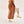 Woman wearing Bogota cream vegan boots styled with long coat and neutral outfit in side pose highlighting chunky sole