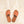 Top view flat lay of Cali vegan sandals in cognac with rose lace detail on stone background