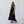 Woman wearing Camila Plus vegan lace up heels with black ribbons styled with black dress in minimal studio setting