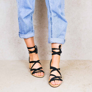 Front view of woman wearing Camila vegan lace up heels with black ribbons styled with rolled up jeans