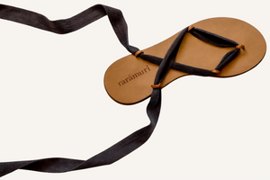 Cancun black vegan lace-up ribbon travel sandals flat lay with extended ribbons