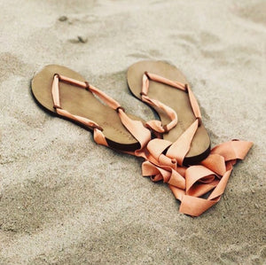 Cancun vegan sandals with peach ribbons on sand, eco friendly lace up sandals for women travel