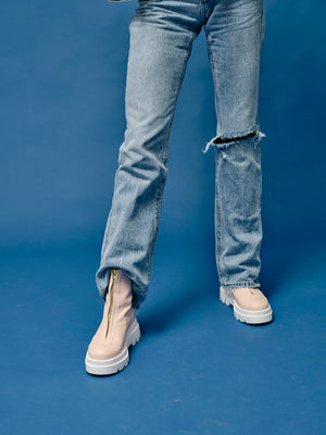 Front view of woman wearing vegan platform boots styled with denim outfit highlighting fit and chunky sole