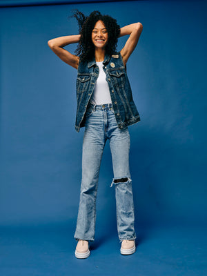 Woman wearing vegan platform shoes styled with denim outfit in studio, casual sustainable fashion look