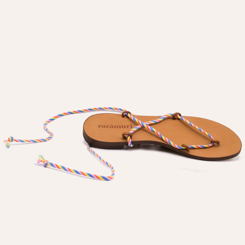 Playful sandals featuring thin, multicolored braided ribbons that add a fun and vibrant twist.