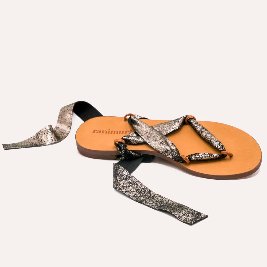 A pair of sandals with snake-print ribbons in grey and black tones for a bold, edgy style.